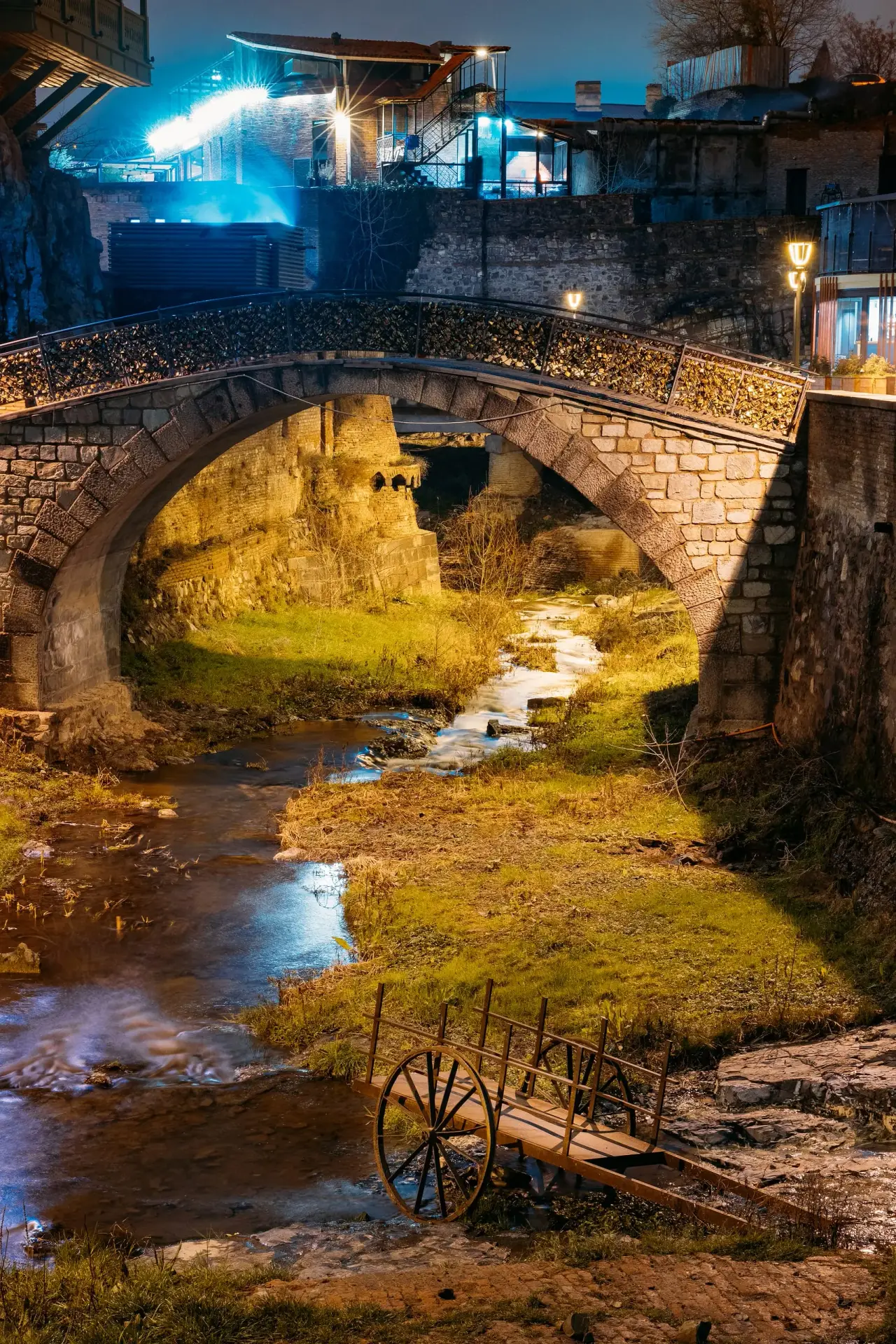 Tbilisi Bridge of Peace illuminated at night, scenic landmark in Georgia